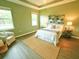 Bright main bedroom with tray ceiling, two windows, and neutral-toned walls at 5718 Broad River Run, Ellenton, FL 34222