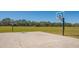 Outdoor basketball court with well-maintained hoops, providing a recreational space with tree lined background at 6373 Royal Tern Cir, Lakewood Ranch, FL 34202