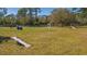 Dog park with various obstacles and play structures on green grass surrounded by mature shade trees at 6373 Royal Tern Cir, Lakewood Ranch, FL 34202