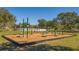 Well-equipped outdoor exercise area with fitness equipment on wood chip ground with secure border at 6373 Royal Tern Cir, Lakewood Ranch, FL 34202