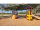 Playground with play structures, slides, and shade canopy, perfect for outdoor recreation and enjoyment at 6373 Royal Tern Cir, Lakewood Ranch, FL 34202