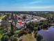 A lovely aerial view of a well-maintained community near a pond and lush trees at 6796 Gasparilla Pines Blvd # 45, Englewood, FL 34224