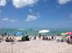 Beautiful beach scene featuring a crowded shore with blue skies and boats in the distance at 6796 Gasparilla Pines Blvd # 45, Englewood, FL 34224