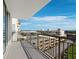 A balcony overlooks nearby buildings and parking garage with blue skies and clouds above at 800 N Tamiami Trl # 517, Sarasota, FL 34236