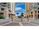 Beautiful fountain featured in the driveway between two high-rise buildings on a sunny day at 800 N Tamiami Trl # 517, Sarasota, FL 34236