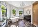 Stunning bathroom features a chandelier, soaking tub, and elegant finishes at 8570 Tropicaire Blvd, North Port, FL 34291