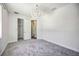 Bright bedroom with gray carpet and contemporary light fixture at 8570 Tropicaire Blvd, North Port, FL 34291