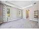 Comfortable bedroom with carpet, tray ceiling and large windows at 8570 Tropicaire Blvd, North Port, FL 34291