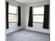 Cozy bedroom with neutral carpet, white walls, and two windows offering plenty of sunlight at 8570 Tropicaire Blvd, North Port, FL 34291