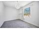 Well-lit bedroom with gray carpet and a large window at 8570 Tropicaire Blvd, North Port, FL 34291