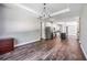 Open dining room flows to the kitchen with tile floor and modern lighting at 8570 Tropicaire Blvd, North Port, FL 34291