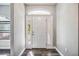 Bright entryway featuring a white front door with sidelights and transom window at 8570 Tropicaire Blvd, North Port, FL 34291