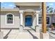 Grand entrance with white columns and a bright blue front door, creating a welcoming facade at 8570 Tropicaire Blvd, North Port, FL 34291