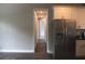 Bright hallway with wood flooring, leading past the kitchen, creating a cohesive flow throughout the home at 8570 Tropicaire Blvd, North Port, FL 34291