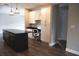 Modern kitchen featuring a large island, sleek black countertops, and stylish cabinetry with an adjacent workspace at 8570 Tropicaire Blvd, North Port, FL 34291