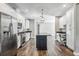 Contemporary kitchen with white cabinetry, stainless steel appliances, and dark granite counters at 8570 Tropicaire Blvd, North Port, FL 34291