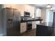 Contemporary kitchen featuring stainless steel appliances, a dark island, and white cabinetry, creating a sleek aesthetic at 8570 Tropicaire Blvd, North Port, FL 34291