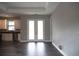 Kitchen with stainless steel appliances, white cabinets, and french doors leading to a covered lanai at 8570 Tropicaire Blvd, North Port, FL 34291