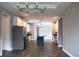 Open concept area with stylish lighting, stainless steel appliances, and dark countertops, all set against wood flooring at 8570 Tropicaire Blvd, North Port, FL 34291