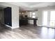 Open concept kitchen boasts modern appliances, a large island, and stylish pendant lighting, all complemented by wood flooring at 8570 Tropicaire Blvd, North Port, FL 34291