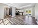 Open-concept living room with wood-look tile flooring and access to the kitchen at 8570 Tropicaire Blvd, North Port, FL 34291