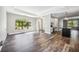 Light-filled living space with wood-look tile flooring, and large windows at 8570 Tropicaire Blvd, North Port, FL 34291