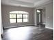 Bright living room showcasing hardwood floors, neutral colors, and a large window for ample natural light at 8570 Tropicaire Blvd, North Port, FL 34291