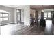 Open-concept living space with hardwood floors, modern lighting fixtures, and a view of the kitchen island at 8570 Tropicaire Blvd, North Port, FL 34291