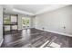 Spacious living area with wood-look tile flooring and natural light streaming in at 8570 Tropicaire Blvd, North Port, FL 34291