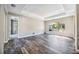 Spacious main bedroom featuring wood-look flooring and a decorative tray ceiling at 8570 Tropicaire Blvd, North Port, FL 34291