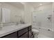 Bright bathroom featuring a single vanity, granite countertop, and a shower-tub combination with glass doors at 8995 Milestone Dr, Sarasota, FL 34238