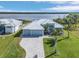 Waterfront home with lush landscaping, a private dock, and a paved driveway on Interceptor Lagoon at 9464 St Marys Ct, Port Charlotte, FL 33981