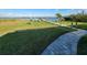 Exterior view of a grassy backyard and patio leading to a private dock at 9464 St Marys Ct, Port Charlotte, FL 33981
