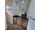 Bathroom featuring granite countertop, undermount sink, and walk-in shower with decorative tile accents at 9464 St Marys Ct, Port Charlotte, FL 33981