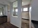 Luxury bathroom featuring dual showers with tile accents, granite countertops, and dark wood cabinetry at 9464 St Marys Ct, Port Charlotte, FL 33981