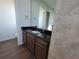 Bathroom featuring wood cabinets with granite counters, undermount sink, and large mirror at 9464 St Marys Ct, Port Charlotte, FL 33981