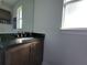 A bathroom vanity with granite countertops and a framed mirror adds a touch of elegance to this home at 9464 St Marys Ct, Port Charlotte, FL 33981