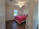 Bright bedroom featuring wood-look floors and a view of the pool at 9464 St Marys Ct, Port Charlotte, FL 33981