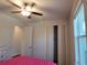 Bedroom with wood-look flooring, closet, and a ceiling fan at 9464 St Marys Ct, Port Charlotte, FL 33981
