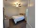 Inviting bedroom features wood-look flooring, ceiling fan, and natural light at 9464 St Marys Ct, Port Charlotte, FL 33981