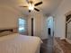 Bright bedroom with hard surface floors features a ceiling fan, and a view to the screened lanai at 9464 St Marys Ct, Port Charlotte, FL 33981