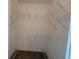 Walk-in closet includes white wire shelving and wood look flooring at 9464 St Marys Ct, Port Charlotte, FL 33981