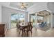 An elegant dining room features wood floors and sliding glass doors to an outdoor patio at 9464 St Marys Ct, Port Charlotte, FL 33981