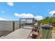 Waterfront home boasts a private dock with a boat lift and comfortable seating for enjoying scenic water views under a blue sky at 9464 St Marys Ct, Port Charlotte, FL 33981