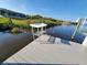 View of a dock with a table and river under a blue sky at 9464 St Marys Ct, Port Charlotte, FL 33981