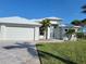 Charming home exterior with a two-car garage, well manicured lawn, and a driveway at 9464 St Marys Ct, Port Charlotte, FL 33981