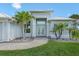 Gorgeous single Gathering home with lush landscaping and a brick paver pathway leading up to the front door at 9464 St Marys Ct, Port Charlotte, FL 33981