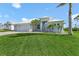 Beautifully landscaped front exterior with a well-manicured lawn and a three-car garage in a desirable neighborhood at 9464 St Marys Ct, Port Charlotte, FL 33981