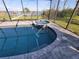 Close-up of the pool with a built-in spa in a screened-in enclosure at 9464 St Marys Ct, Port Charlotte, FL 33981