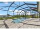 The screened-in pool features a spa and an outdoor grill with a water view and private boat dock access at 9464 St Marys Ct, Port Charlotte, FL 33981